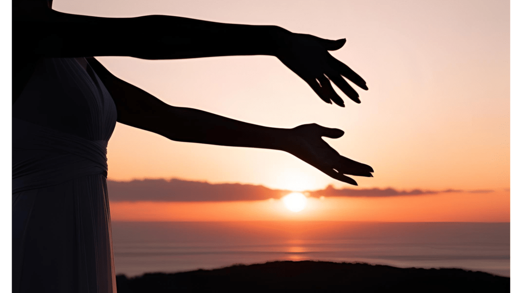 Silhouette of a person reaching out towards a sunset, conveying a sense of freedom or longing.